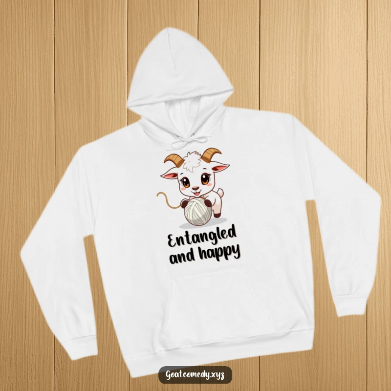 Funny goat hoodie showing a goat with wide, captivated eyes chasing a bouncing ball of yarn.
